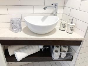 a bathroom counter with a sink and towels at Altana Mario in Piran