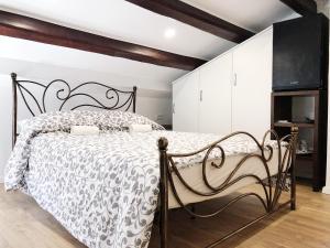 a bedroom with a bed with a black and white comforter at Altana Mario in Piran