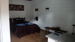 a bedroom with a bed and a table in it at Villaggio D'Amore in Monte Verde