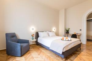 Ένα ή περισσότερα κρεβάτια σε δωμάτιο στο Klepsydra Urban Suites