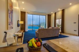 a living room with a table with a bowl of fruit at Tamara Beach Resort, Al Khobar Half Moon Bay-"Families Only" in Half Moon Bay