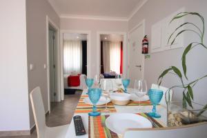 a dining room with a table with blue wine glasses at Ferhouse Dreams-Farilhões in Nazaré