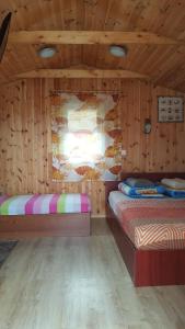 a bedroom with two beds in a wooden cabin at Žuvėdrų g. 27 in Šventoji