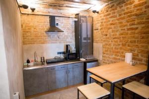 a kitchen with a sink and a wooden table at Vysoka Khata2 in Lviv