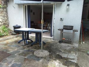 a blue table with an umbrella on a patio at d17 studio pietra in Mucchio +16 photos