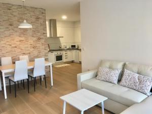 a living room with a couch and a table at APARTAMENTO SAN MIGUEL N.2 in Jarandilla de la Vera