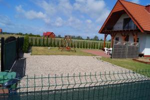 a playground with a swing set in a yard at Domki Alex I Maciek in Pleśna