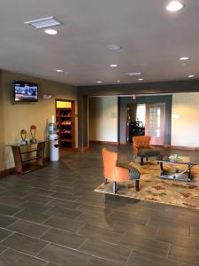 a lobby with furniture and a flat screen tv at Countryview Inn & Suites in Robinson