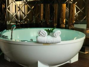 a bath tub with two folded towels in it at Hotel Deluxe in Tirana +95 photos