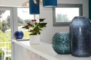 a kitchen with two blue vases sitting on a counter at Hotel La Voile in Bormes-les-Mimosas