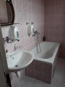 a bathroom with a sink and a bath tub and a mirror at "Park" in Visoko