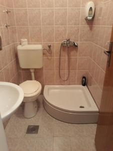 a bathroom with a toilet and a tub and a sink at "Park" in Visoko