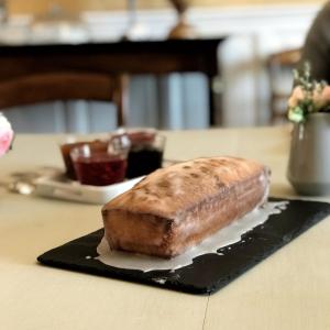 a loaf of bread sitting on a plate on a table at Domaine de Gailhaguet B&B in Verfeil