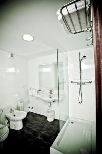 
a bathroom with a shower, sink, toilet and tub at Hotel Maycar in A Coruña
