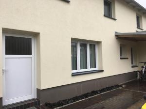 a white door on the side of a house at Appartment Maggy in Bad Liebenwerda