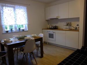 a kitchen and dining room with a table and chairs at Apartmani Berno in Starigrad