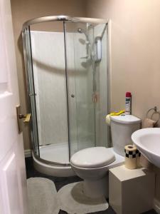 a bathroom with a shower and a toilet and a sink at Pier View b&b for families in Blackpool