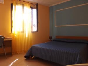 Кровать или кровати в номере Hotel Ristorante Al Canto delle Sirene