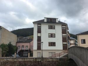 a large white building with a black roof at Hotel La Bilbaina de Vegadeo in Vegadeo