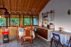 a kitchen and dining room with a table and chairs at Casa Haralambie in Greci