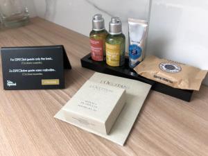 a table with two bottles of alcohol and a box at Design & Wine Vila Special Bled in Bled