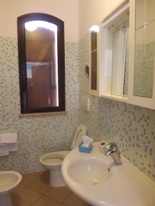 a bathroom with a sink and a toilet at Hotel Ristorante Al Canto delle Sirene in Terracina +34 photos