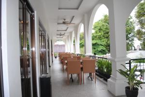 a row of tables and chairs in a building at Casa de Wanea Hotel in Manado