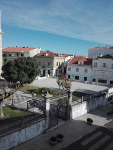 a view of a city with buildings and a fence at Largo da Igreja in Figueira da Foz