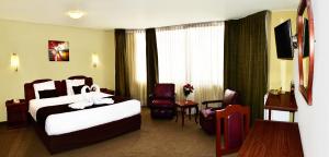 a hotel room with a bed and a tv at Hoteles Riviera Cayma in Arequipa +24 photos