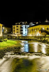 a small river at night with buildings in the background at Hotel La Bilbaina de Vegadeo in Vegadeo