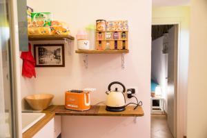 a kitchen with a tea kettle on a wooden shelf at Guest Art Napoli in Naples