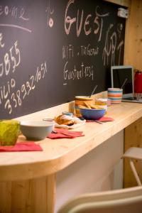 a table with bowls of food and a chalkboard at Guest Art Napoli in Naples