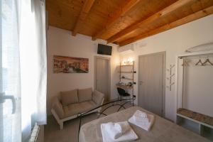 a room with a bed and a couch in it at Casa Lagunare in Chioggia