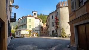 an empty street in a town with buildings at Porta Rose in Garessio