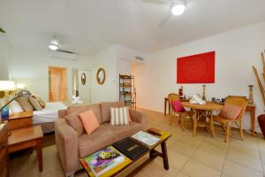 a living room with a couch and a bed at Seascape Holidays at Portsea in Port Douglas