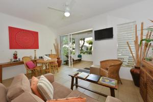 a living room with a couch and a table at Seascape Holidays at Portsea in Port Douglas