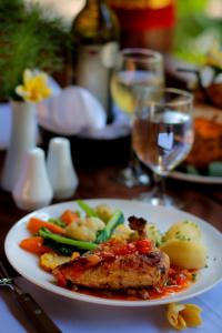 a plate of food with meat and vegetables on a table at Crystal Bay Villa in Nusa Penida