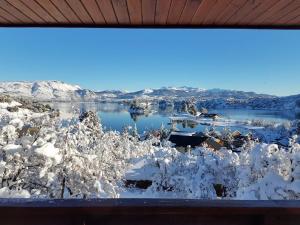 a view of a lake covered in snow at Cabañas & Lofts Las Terrazas in Villa Pehuenia