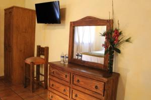 a wooden dresser with a mirror on top of it at Meson Luna Sacra in Tapalpa