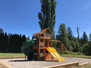 a playground with a slide and a play structure at Kokanee Glacier Resort in Nelson