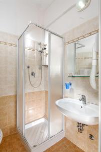 a bathroom with a shower and a sink at Hotel Colombo in Rimini
