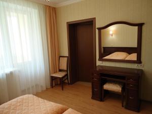 a bedroom with a mirror and a bed and a desk at Apart-Hotel Kurkino in Moscow