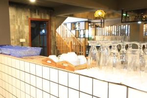 a counter with wine glasses and plates on it at Guilin Lakeside Yige Hotel in Guilin