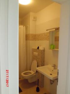 a bathroom with a toilet and a sink at Apartments Viskovic in Makarska +113 photos