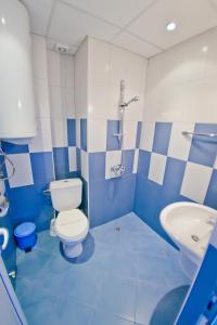 a blue and white bathroom with a toilet and a sink at Villas Sequoia in Golden Sands +47 photos