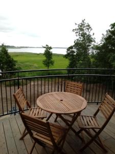 a wooden table and two chairs on a deck at Sis Dziwnowek in Dziwnówek