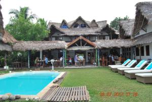a resort with a swimming pool and lounge chairs at Villa Valiha Boutique Hotel in Ambatoloaka