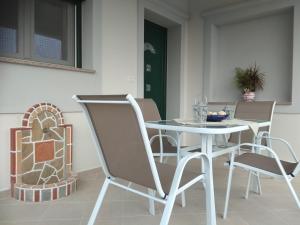 a white table and chairs in a room at Myrina View in Mirina