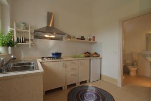 a kitchen with a sink and a stove at Agriturismo Masseria Gianferrante in Ugento +98 photos