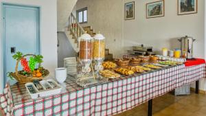 un buffet con comida en una mesa roja y blanca en Neon Hotel, en Stalida